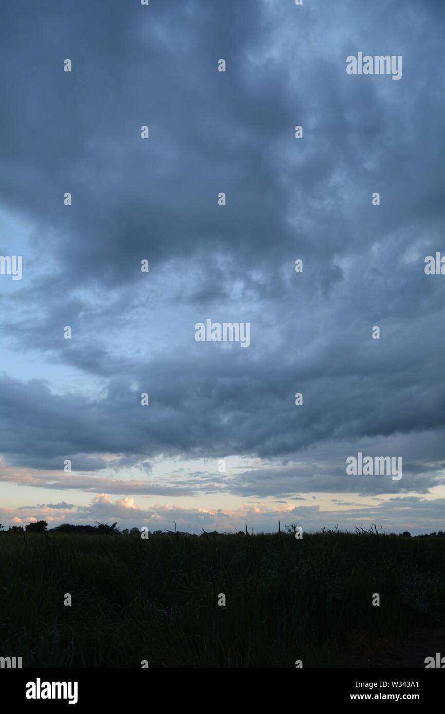 Rolling clouds  at dusk heavy and mixing a strange pattern in the sky. Stock Photo