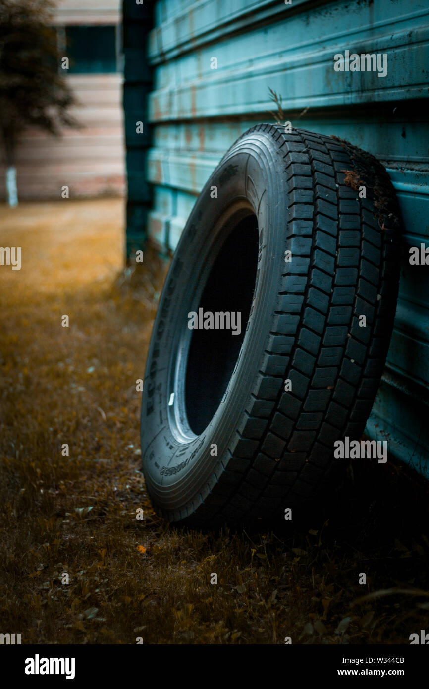 Tire leaning on the wall Stock Photo Alamy