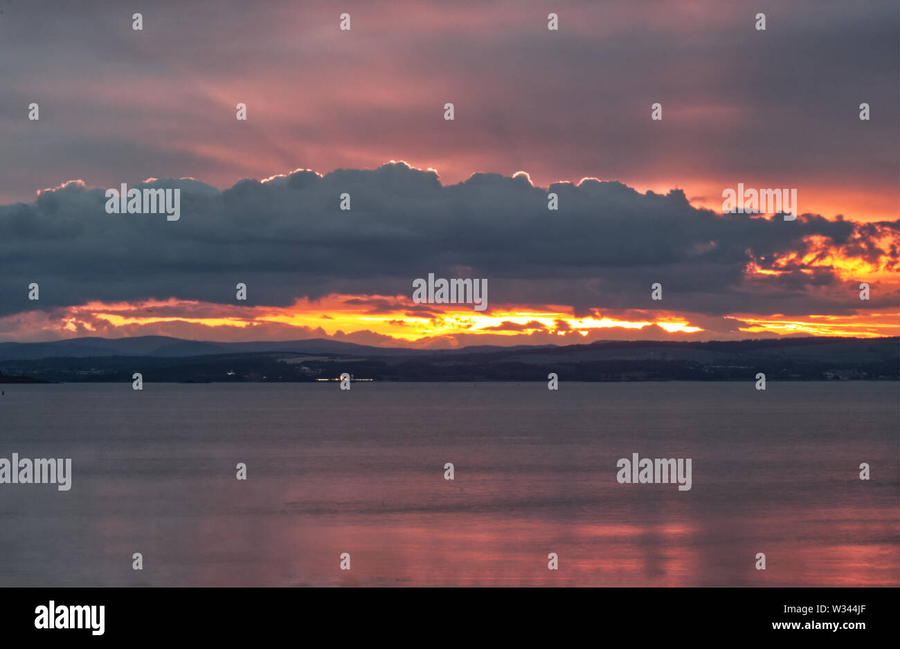 A beautiful landscape picture of a sunset over the Firth of Forth near Edinburgh in Scotland, United Kingdom Stock Photo