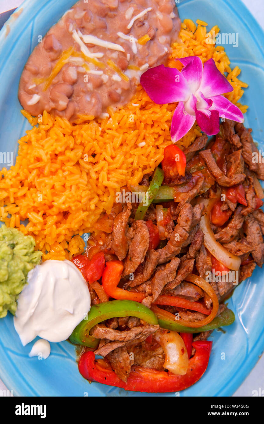 Authentic Mexican Cuisine Steak Fajitas With Rice And Refried Pinto Beans Stock Photo Alamy
