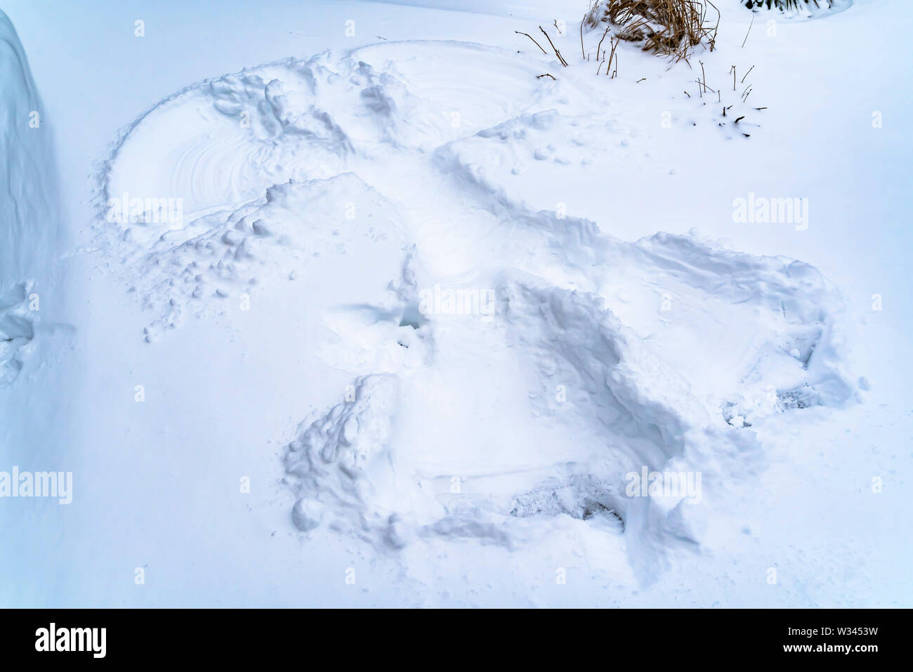 Close up of snow covered ground in winter with a snow angel Stock Photo