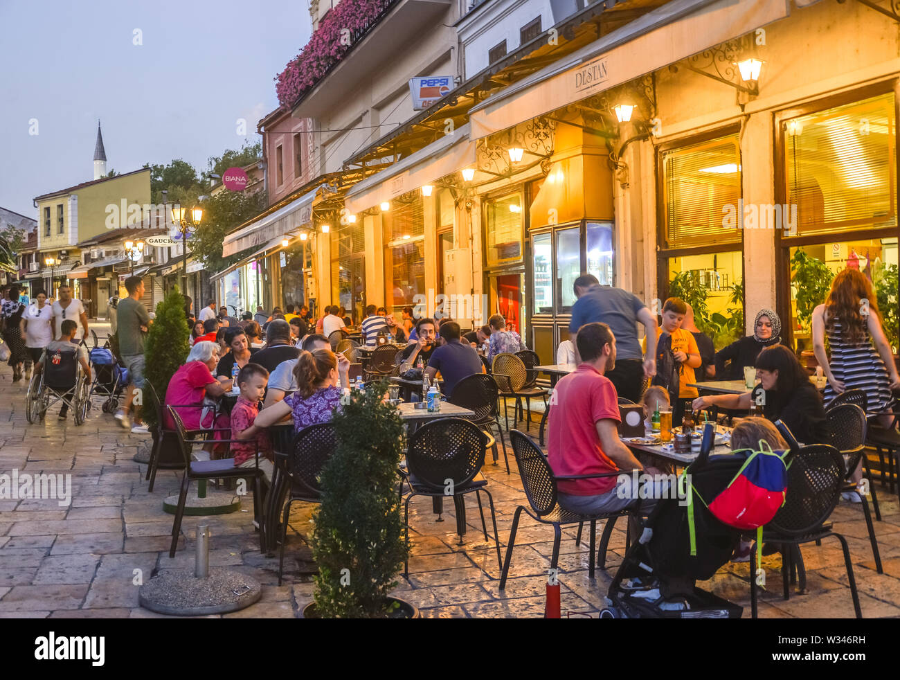 SKOPJE,NORTH MACEDONIA-AUGUST 22 2019:Pedestrians and restaurant customers stroll and mingle around the streets of Old Bazaar area,Skopje. Stock Photo