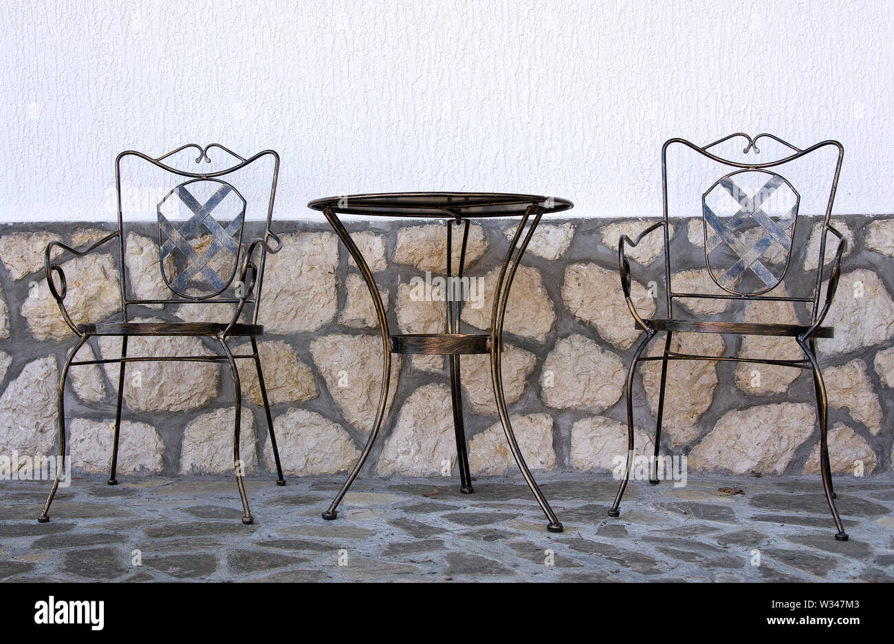 Table and chair in garden Stock Photo - Alamy