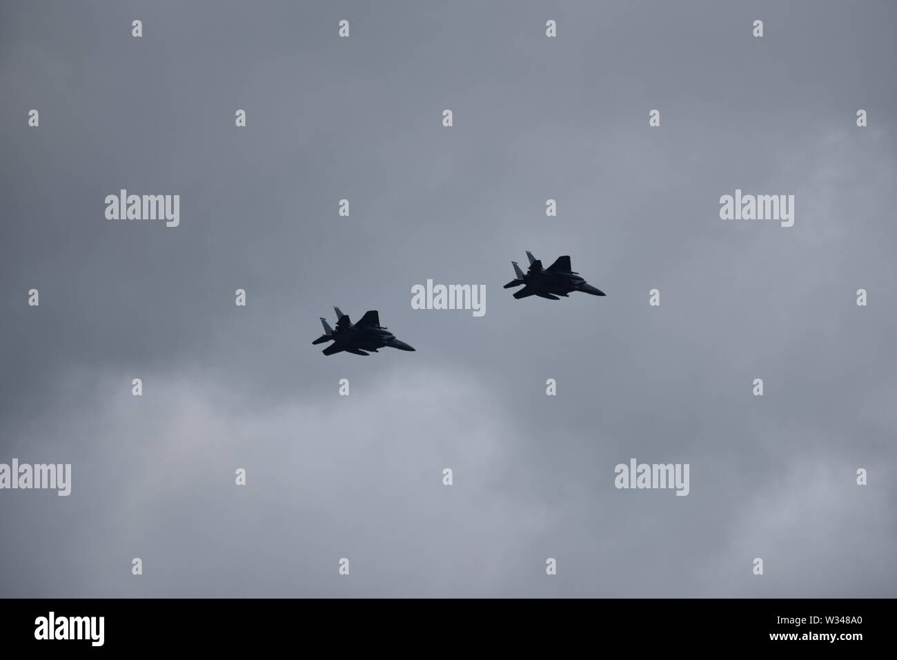 Pair of F 15 Eagle American jet fighter planes in the distance flying ...