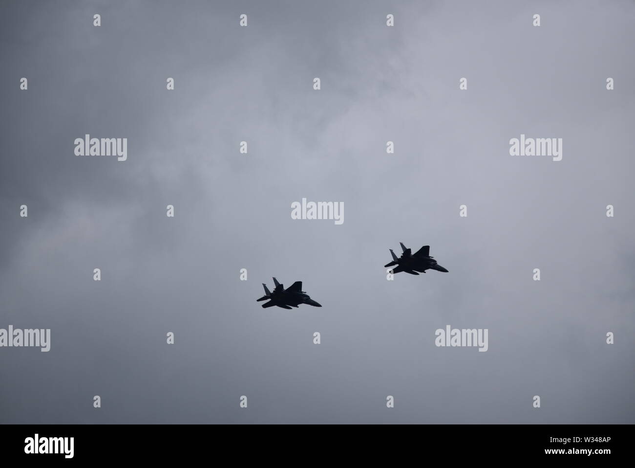 Pair of F 15 Eagle American jet fighter planes in the distance flying ...