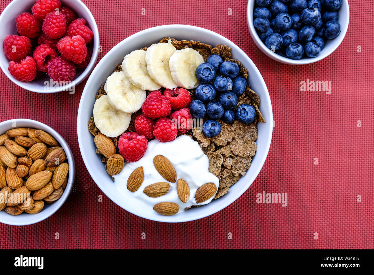 Health Breakfast Bowl of Cereals Fresh Fruit and Nuts With Yogurt in White Bowls Stock Photo