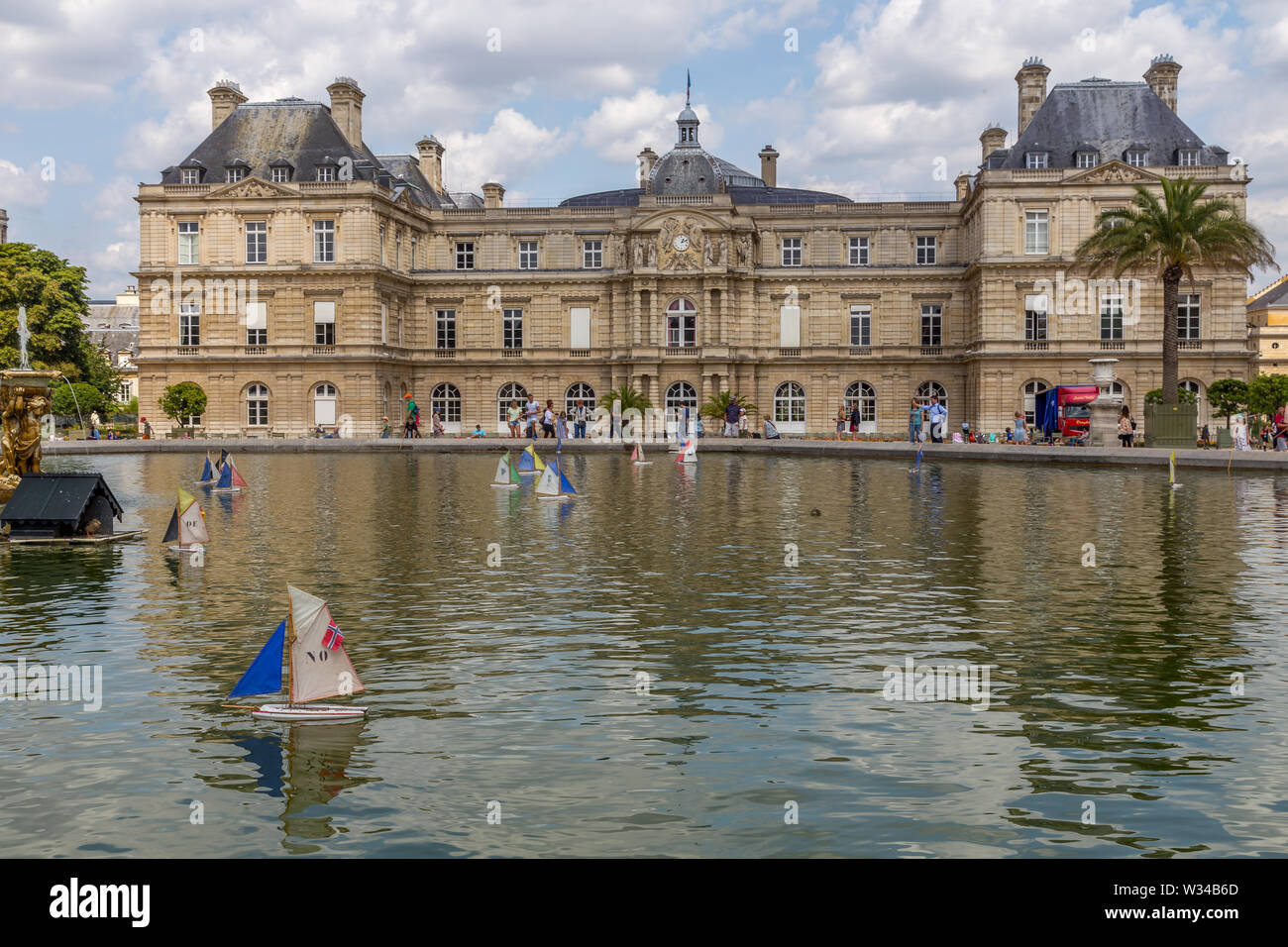 Paris, France - August 5, 2014: casual scenes at the Jardin du Luxembourg park at Paris, with people, boats and the palace Stock Photo