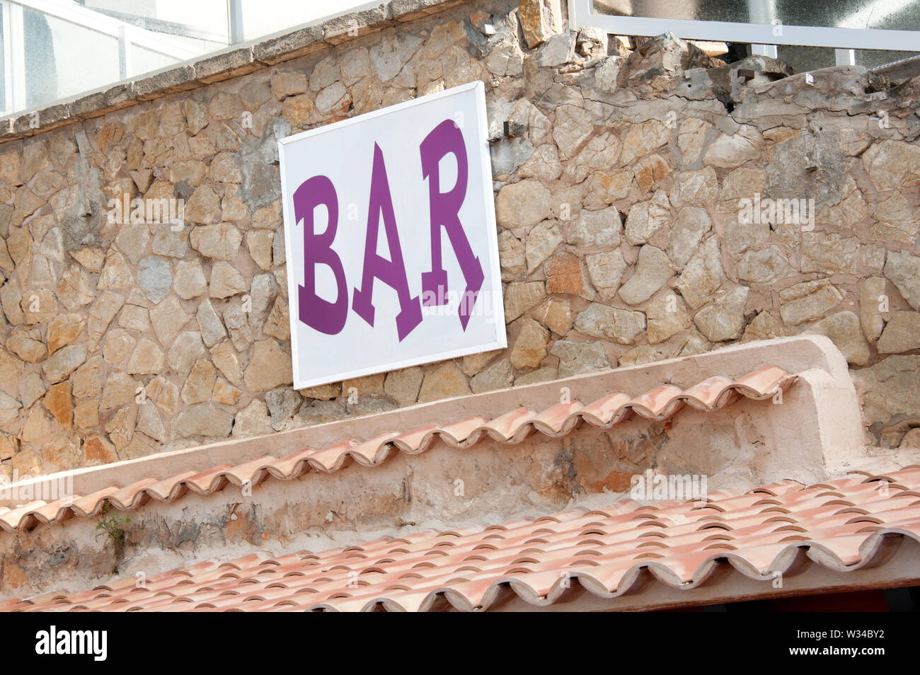 Bar sign on brick wall at mediterranean restaurant Stock Photo