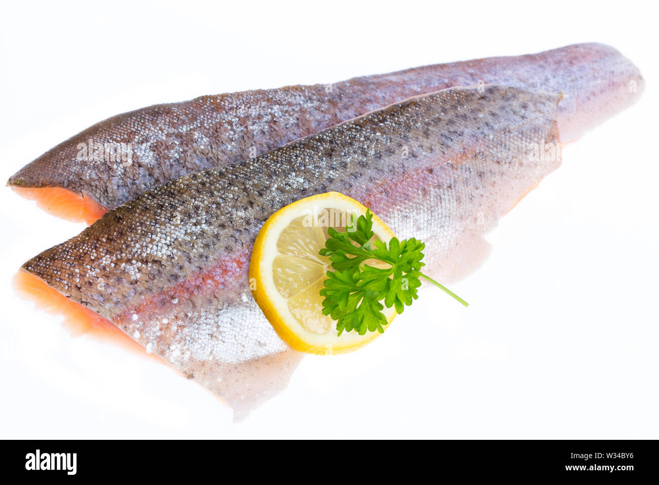 Two filets of salmon trout with a slice of lemon Stock Photo