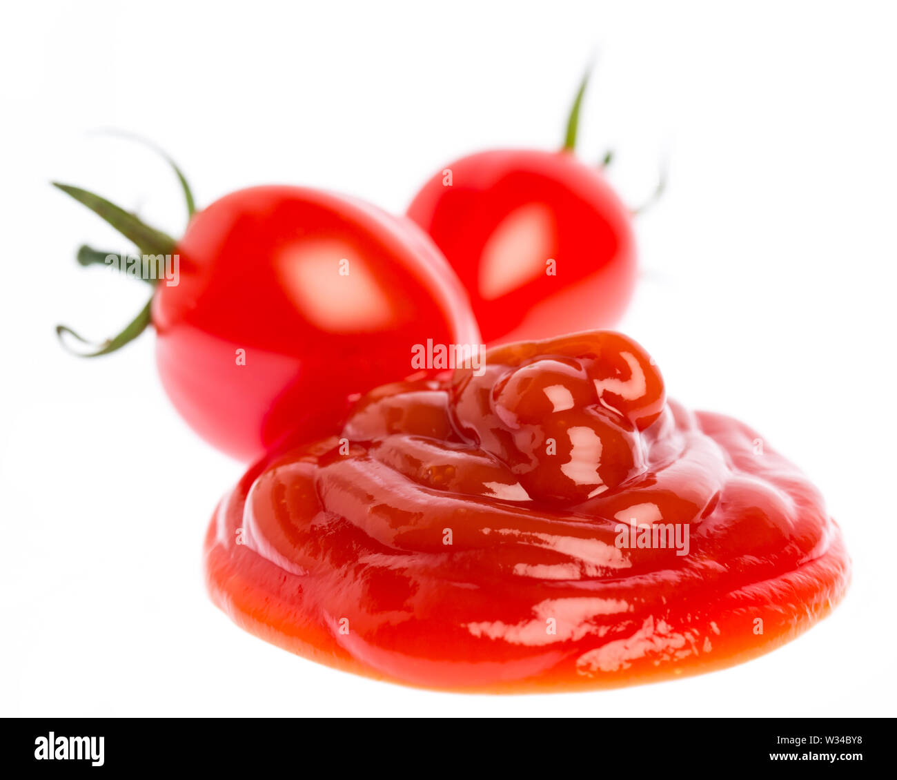 Tomato ketchup with tomatoes isolated on white background Stock Photo