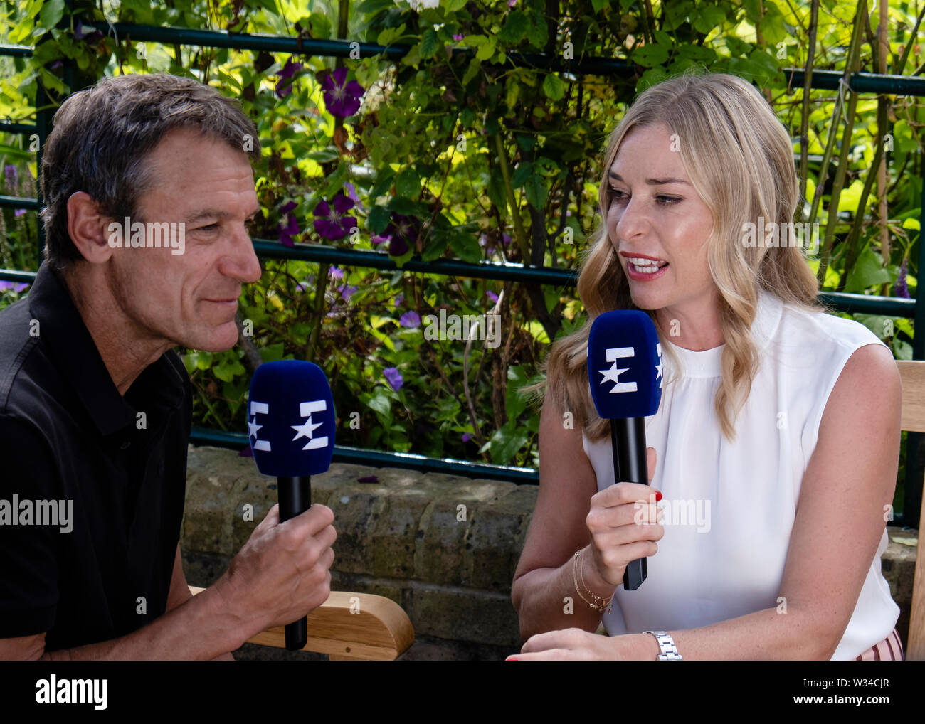 London, UK. 12th July, 2019. Mats Wilander (l) and Barbara Schett talk in  front of the camera for TV channel Eurosport at day 11 at the Wimbledon  Tennis Championships 2019 at the