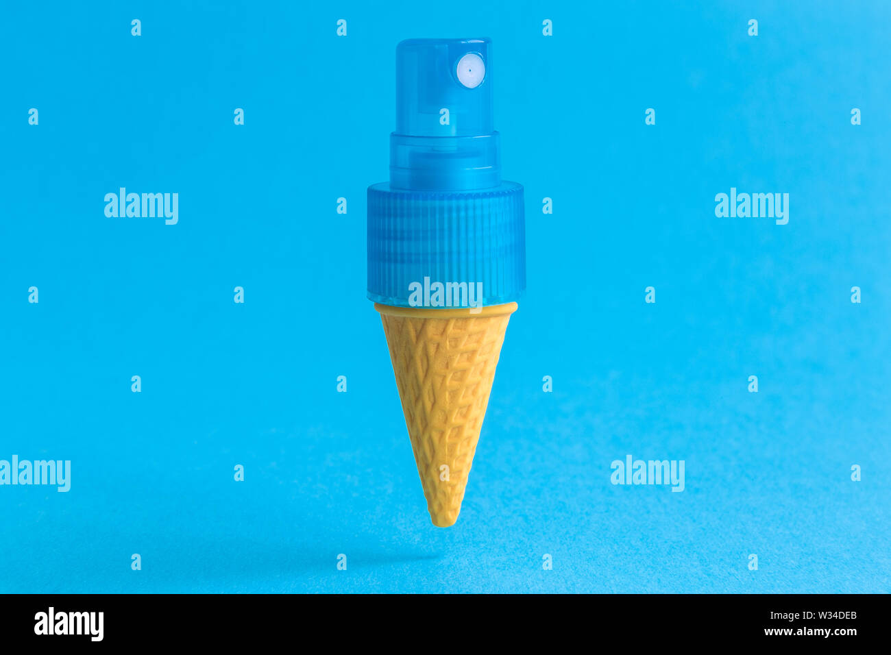 Ice cream cone with perfume spray against pastel blue background minimal  creative concept Stock Photo - Alamy