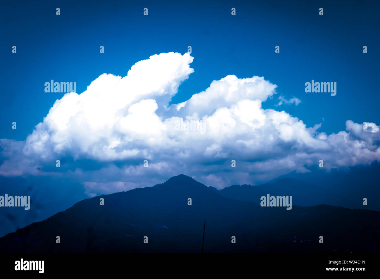 Background photo of Cloudy overcast morning at himalayan mountains. Dreamy landscape. Fluffy weather. Beauty of wild east asian indian nature. Magnifi Stock Photo
