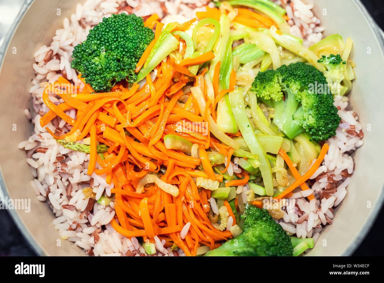 Brown Rice With Organic Unmixed Peeled Sliced Vegetables Cooking In Cast Iron Saucepan Bright Broccoli Carrot And Zucchini Over Cereal Background V Stock Photo Alamy