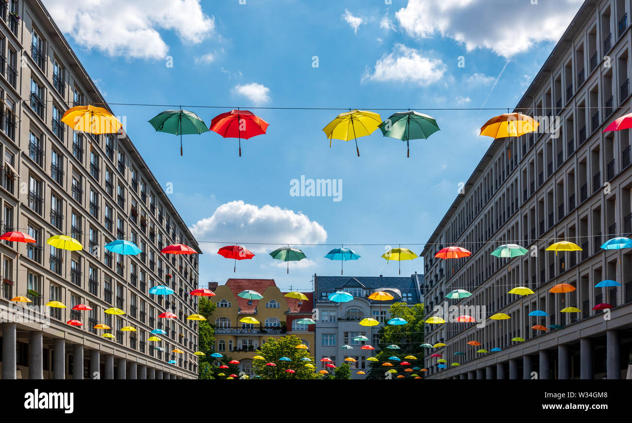 Colourful umbrellas suspended across Walter Benjamin Platz square in Berlin Stock Photo