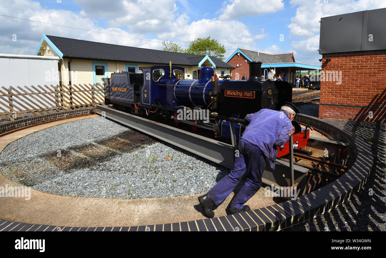 Blickling Hall Narrow Gauge Steam Train on the turntable being push around at Wroxham Station on the Bure Valley Railway Norfolk. Stock Photo