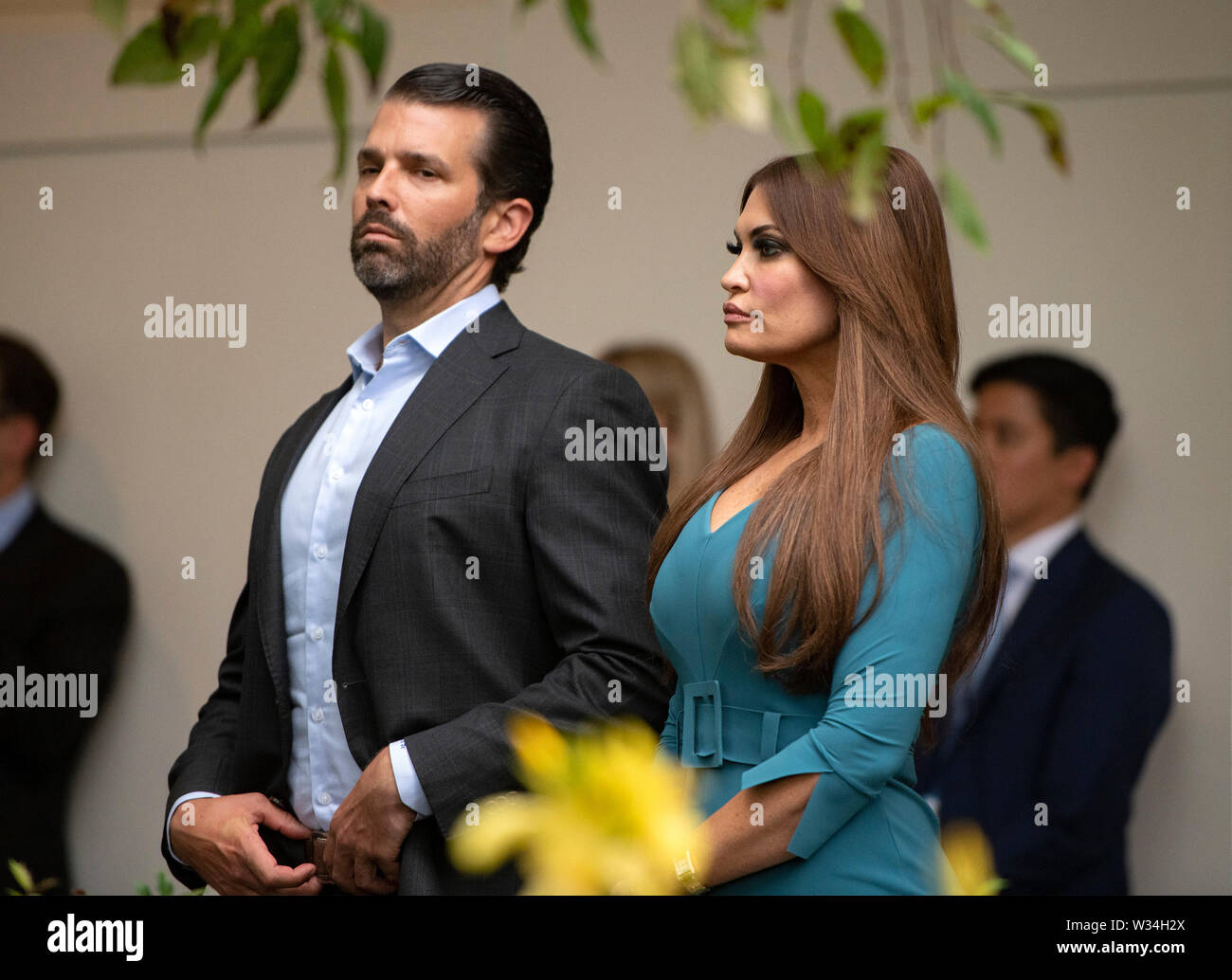 Donald J. Trump, Jr., left, and Kimberly Guilfoyle, right, listen as United States President Donald J. Trump delivers remarks on citizenship and the census in the Rose Garden of the White House in Washington, DC on Thursday, July 11, 2019.Credit: Ron Sachs/CNP /MediaPunch Stock Photo