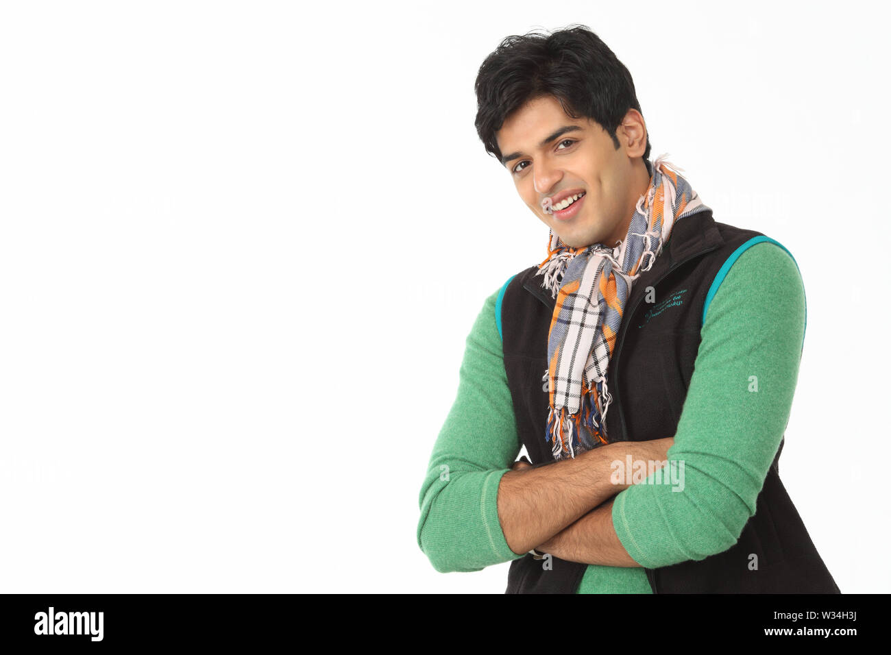Portrait of an Indian young man smiling with his arms crossed Stock ...