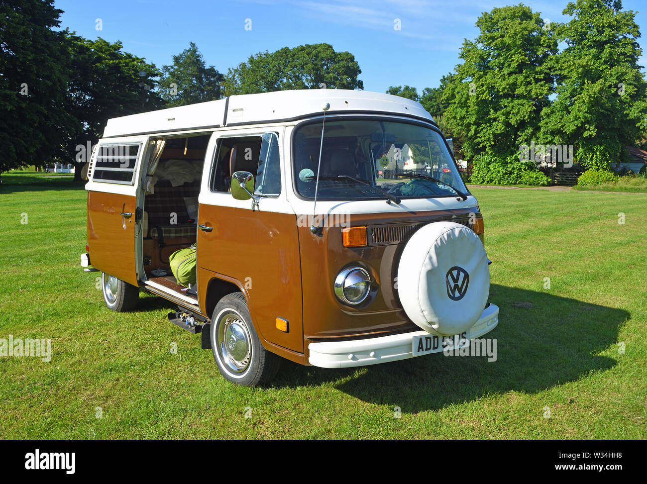 Classic Brown and White Volkswagen Car Parked on Village Green. Stock Photo