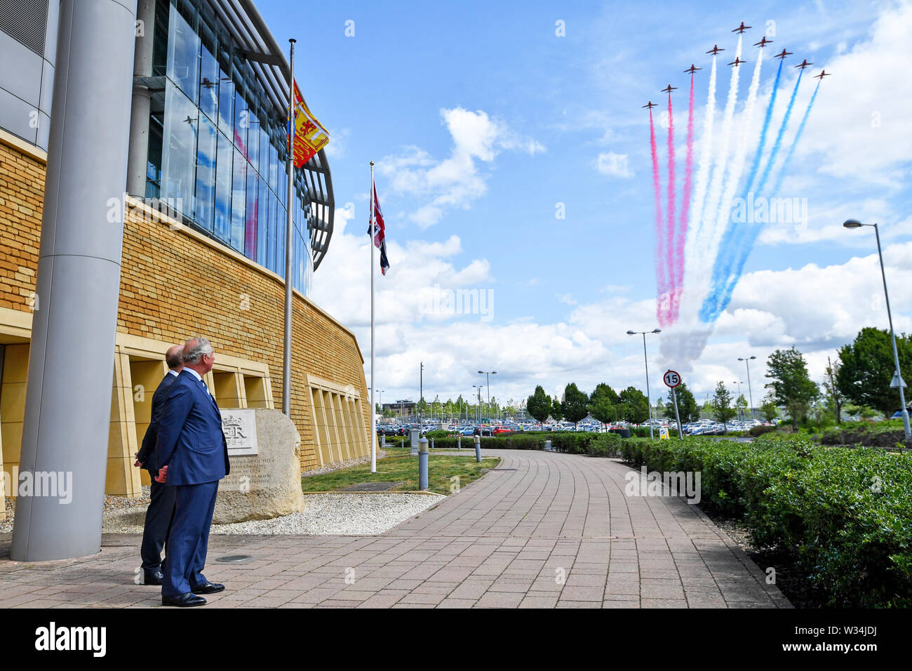 The Prince of Wales, as Patron of the Intelligence Agencies, watches a Red Arrows fly past during a visit to the Government Communications Headquarters, commonly known as GCHQ, in Cheltenham, as part of the agency's centenary celebrations. Stock Photo