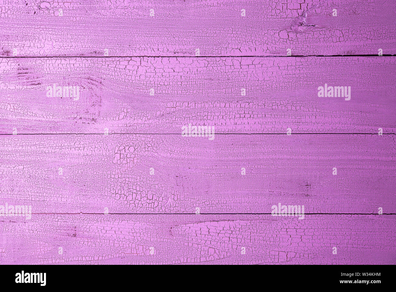 Highly detailed old natural wooden planks painted in beautiful pink color with cracks. Background with horizontal layout and copy space. View from abo Stock Photo