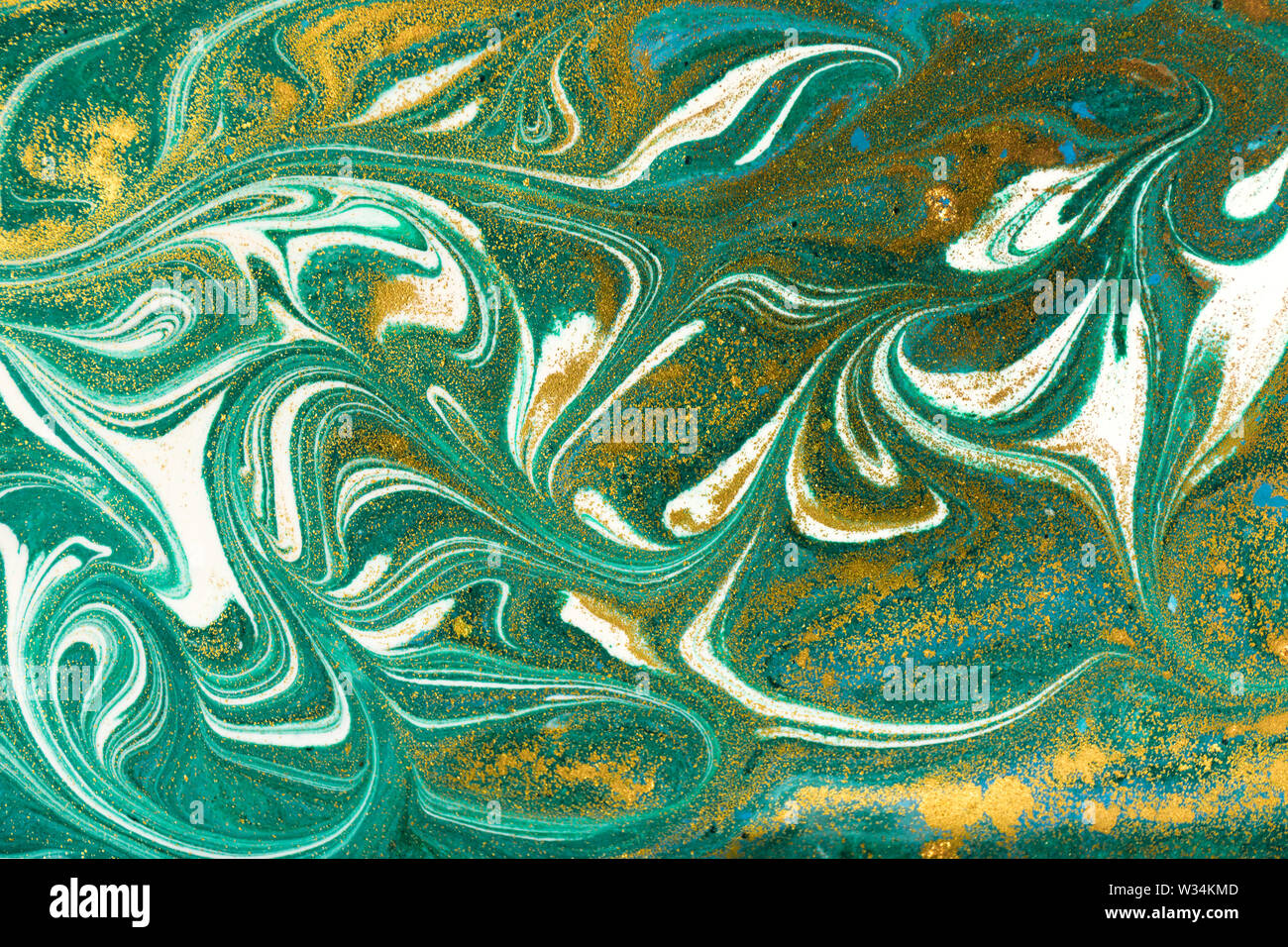 Liquid uneven green marbling pattern with golden glitter and glare of ...