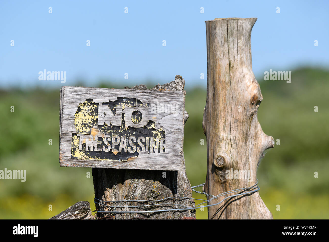 A weathered No Trespassing sign on a farm near Carden Alvar Provincial Park in the Kawartha Lakes region of Ontario, Canada. Stock Photo