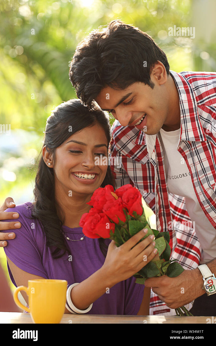 Man giving flowers to a woman Stock Photo Alamy