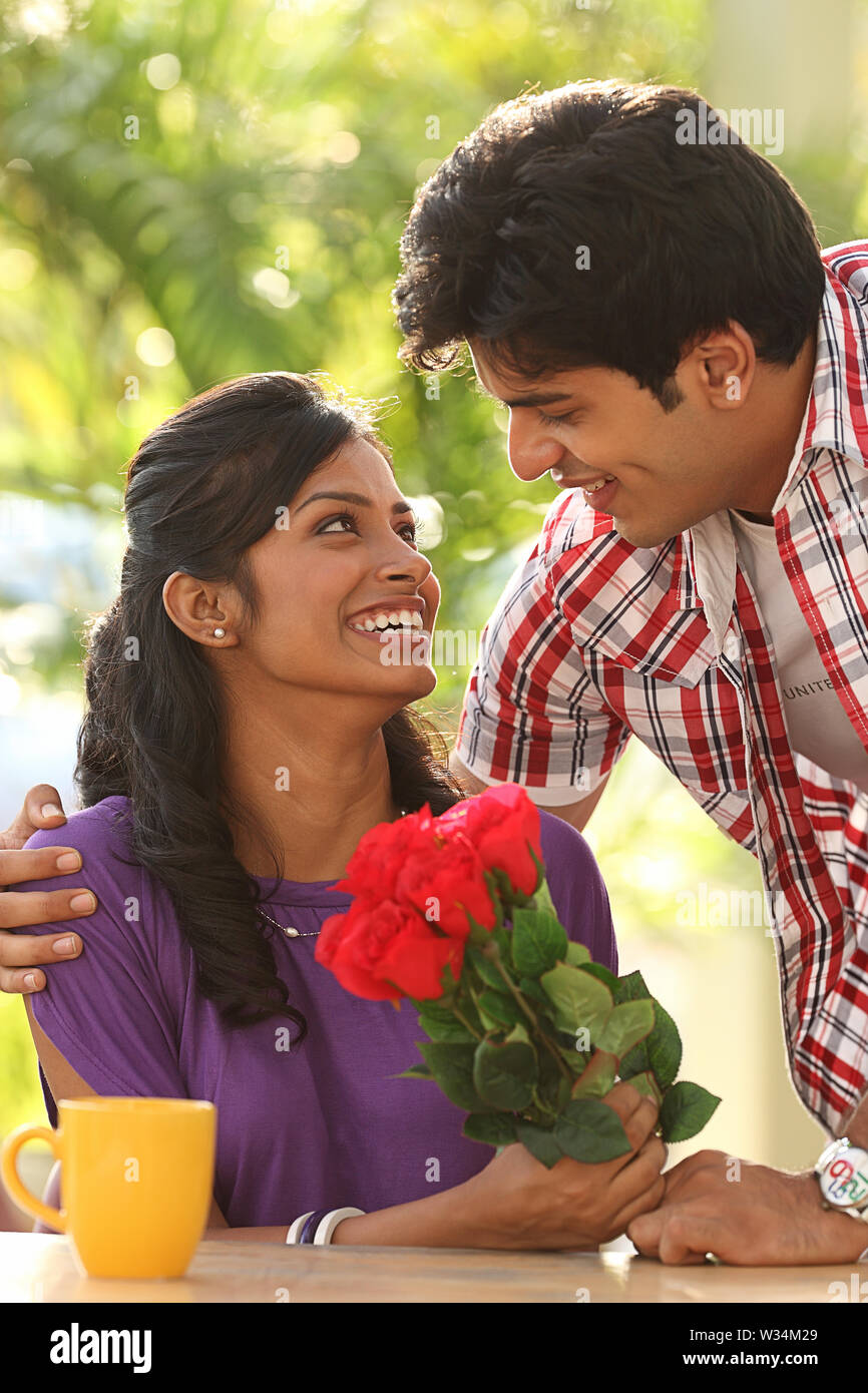 Man giving flowers to a woman Stock Photo Alamy