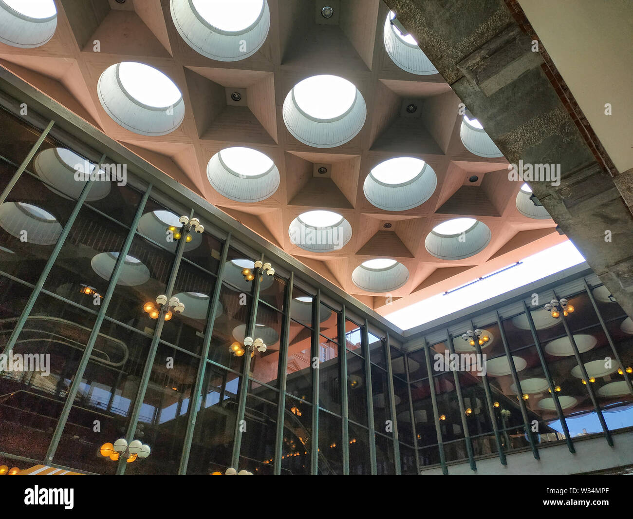 Turin, Piemonte, Italy. June 2019. At the Teatro Regio, detail of the modern structure, natural light enters from the large circular portholes illumin Stock Photo