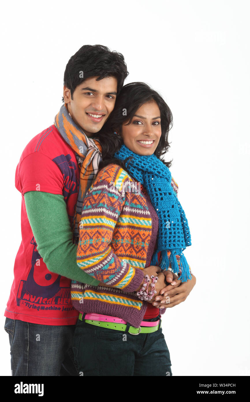 Young man embracing a woman from behind and smiling Stock Photo - Alamy