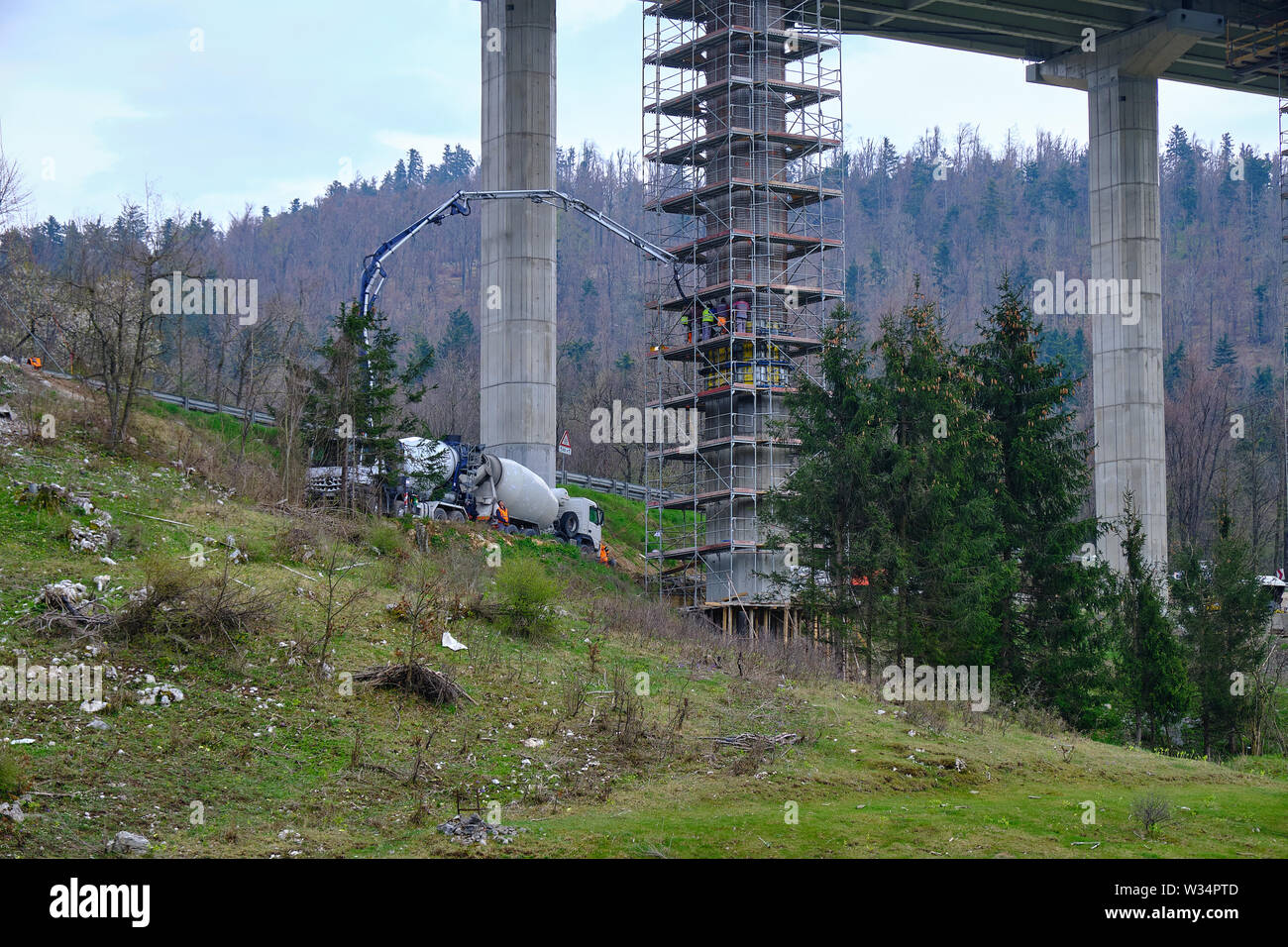 Slovenia: Crew of workers working on repair and maintenance of the substructure on an elevated highway.  Pylons are surrounded by scaffolding Stock Photo