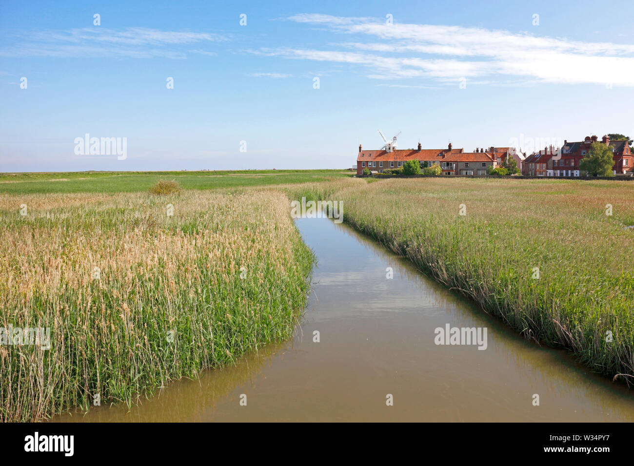 A view of the River Glaven approaching Cley Windmill on the North Norfolk coast at Cley-next-the Sea, Norfolk, England, United Kingdom, Europe. Stock Photo
