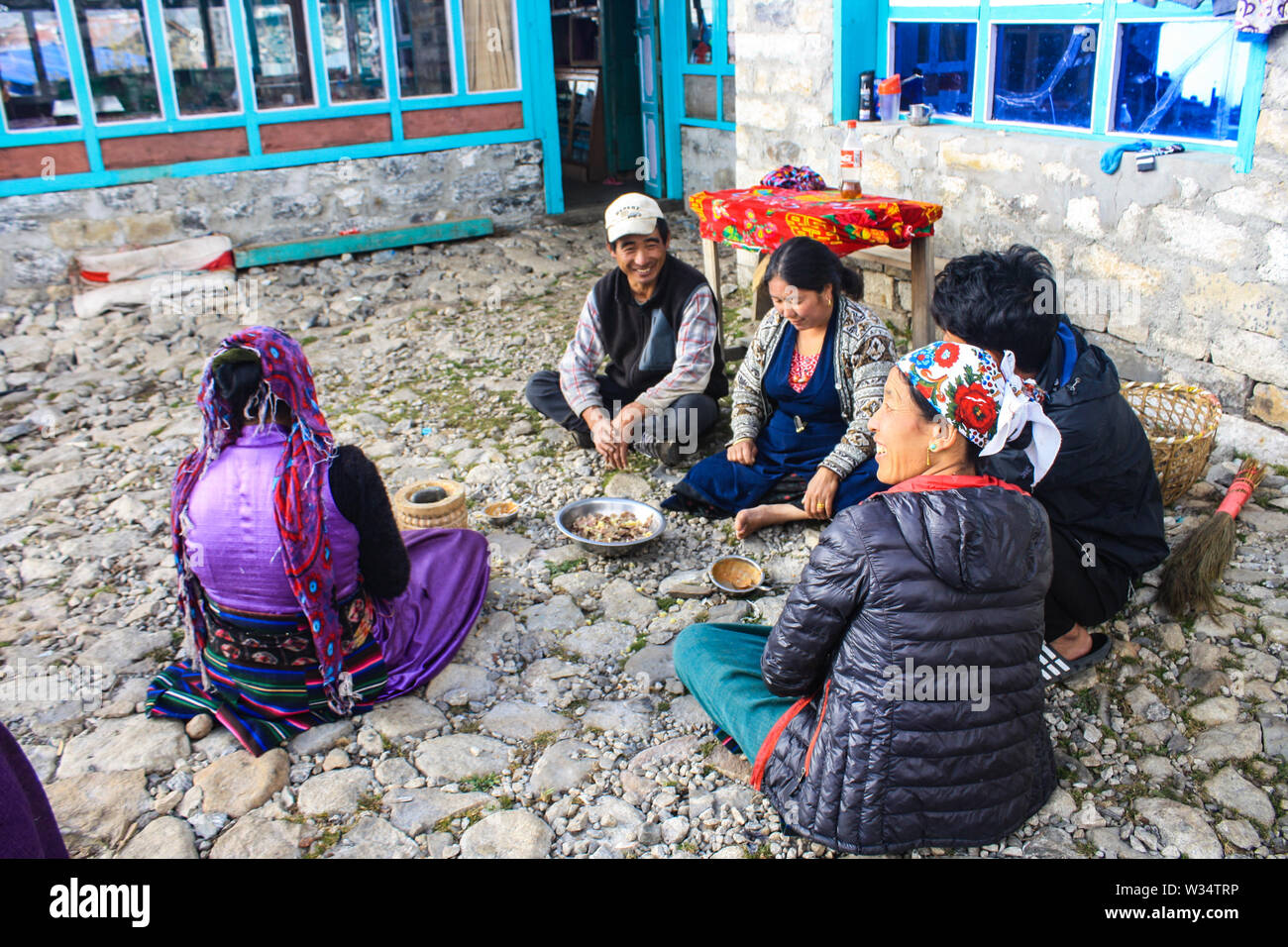 Lunchtime after work in the potato field. Local people having lunch (boiled potatoes) in the group. Stock Photo