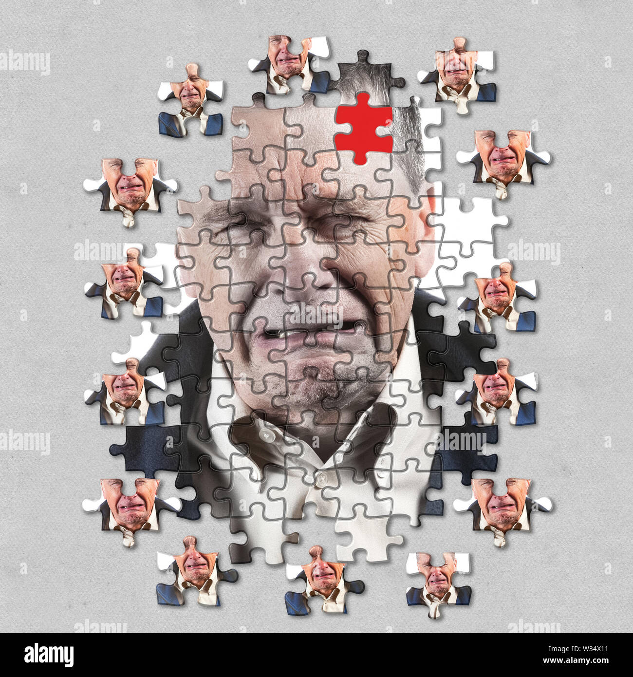 Jigsaw concept of mental illness or dementia with senior caucasian man weeping and alone Stock Photo