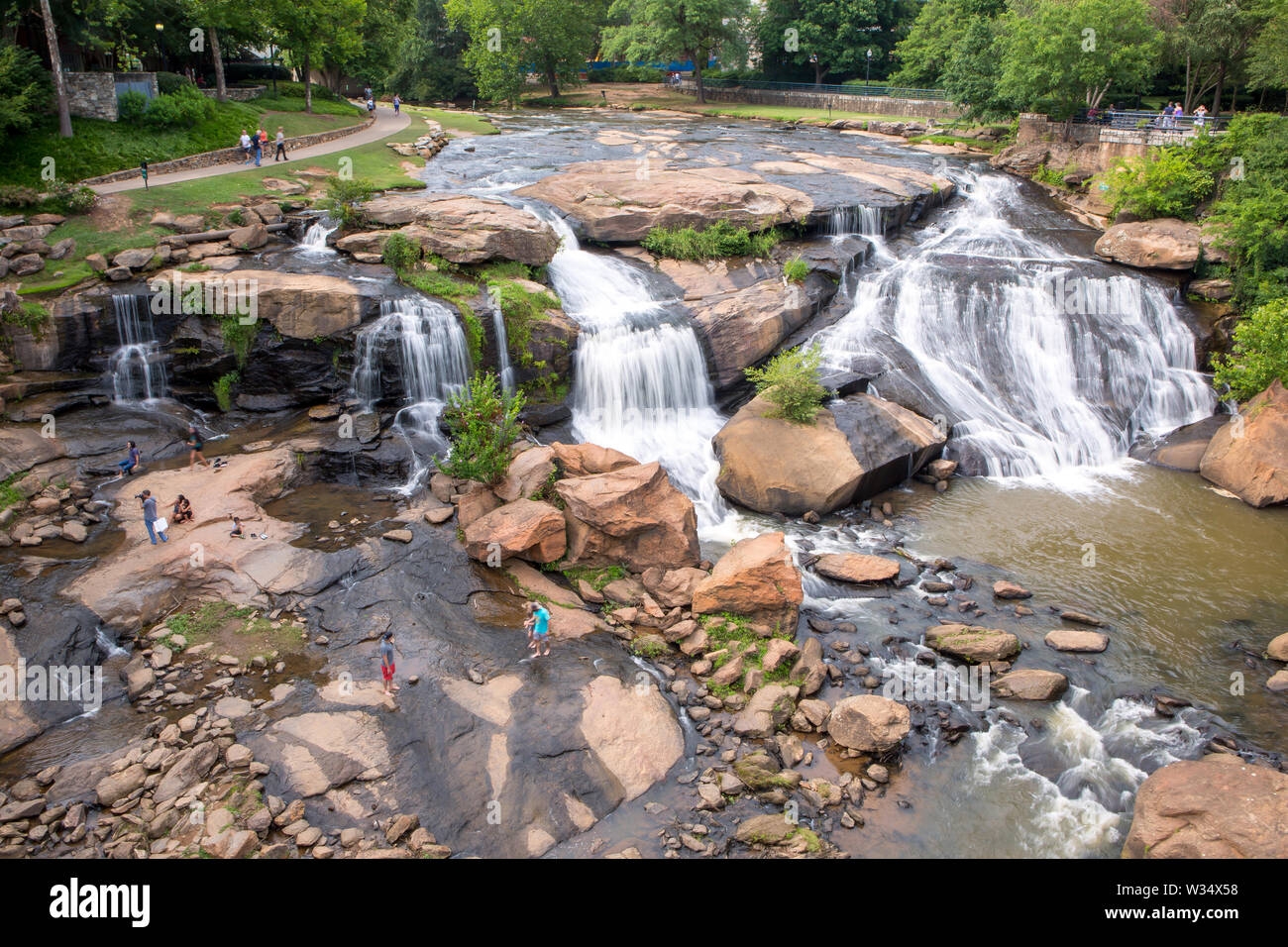 A view of the Reedy River Falls in Falls Park in downtown Greenville, South Carolina, viewed from the Liberty Bridge. Stock Photo