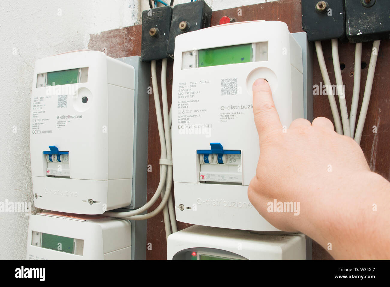 Milano, Italy - July 12, 2019 - Man checks the consumption on the new  e-distributione (enel) electricity meter Stock Photo - Alamy