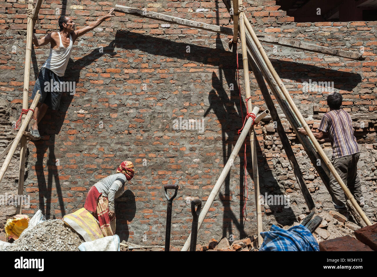 Nepalese reconstructing a building in Kathmandu after the Earthquake of 2015 Stock Photo