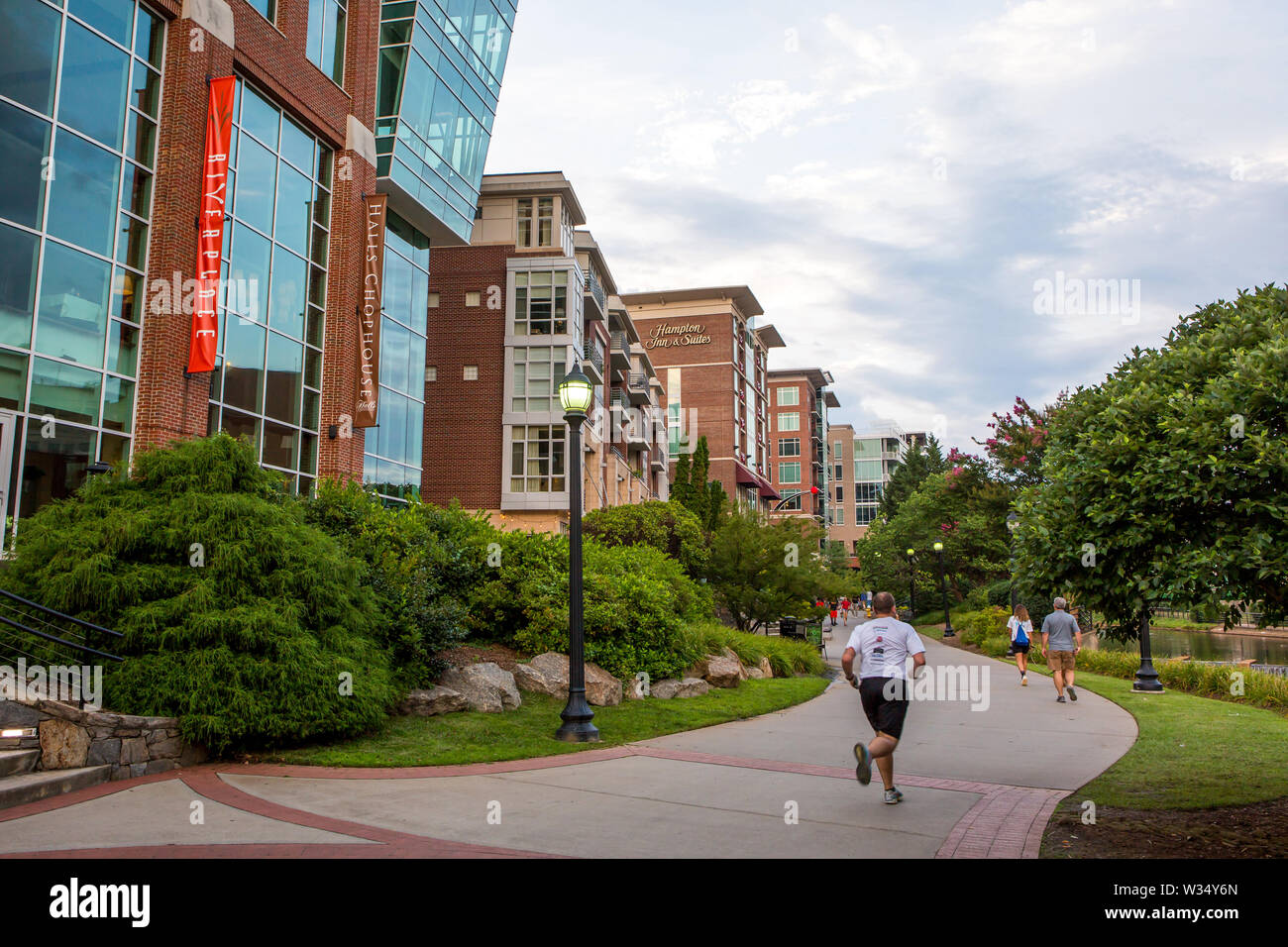 GREENVILLE, SC (USA) - July 5, 2019: A view of the downtown River Walk along the Reedy River and the River Place development of shops and restaurants. Stock Photo
