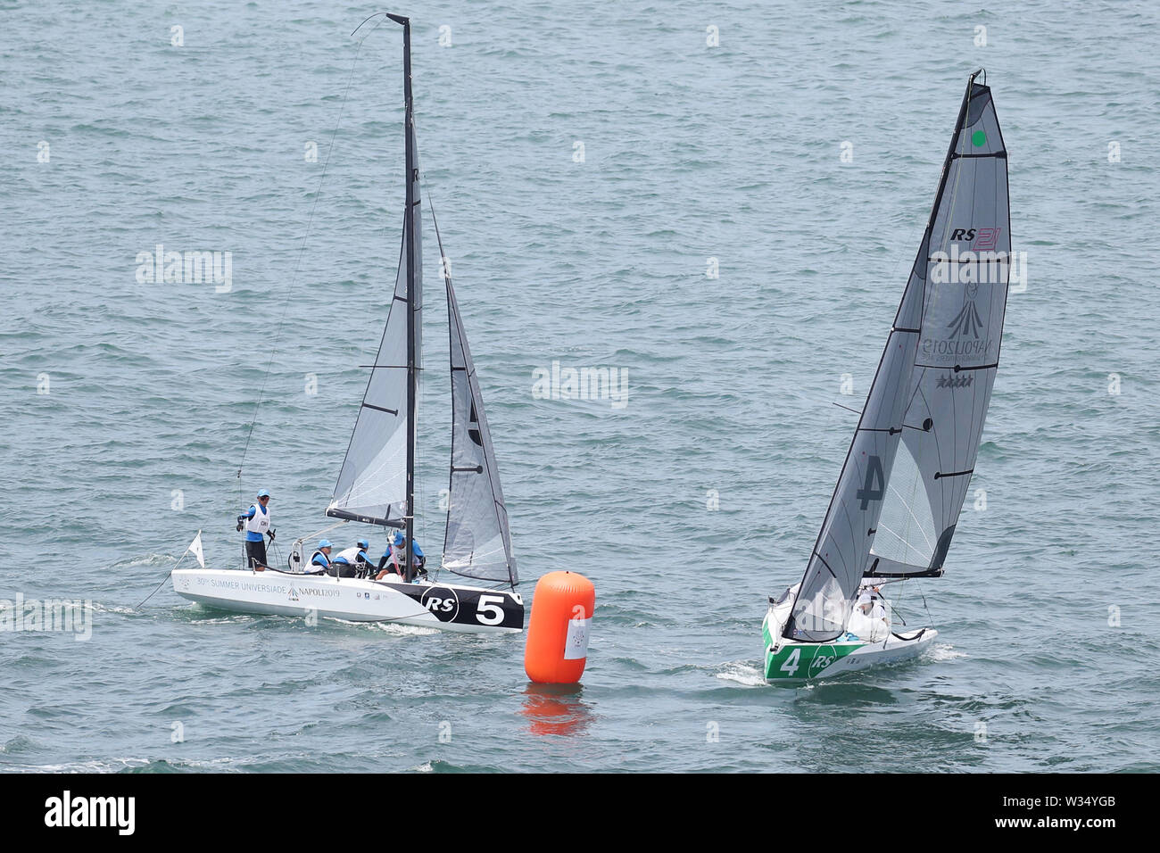 Naples, Italy. 12th July, 2019. Sailors of China (L) prepare to turn at a buoy during the Petit Final of RS21 Mixed Fleet Racing of Sailing at the 30th Summer Universiade in Naples, Italy, July 12, 2019. Credit: Zheng Huansong/Xinhua/Alamy Live News Stock Photo