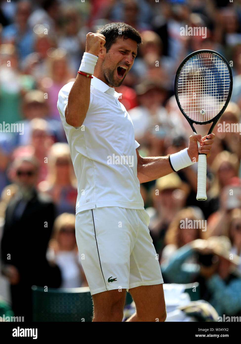 Novak Djokovic celebrates his victory over Roberto Bautista Agut on day eleven of the Wimbledon