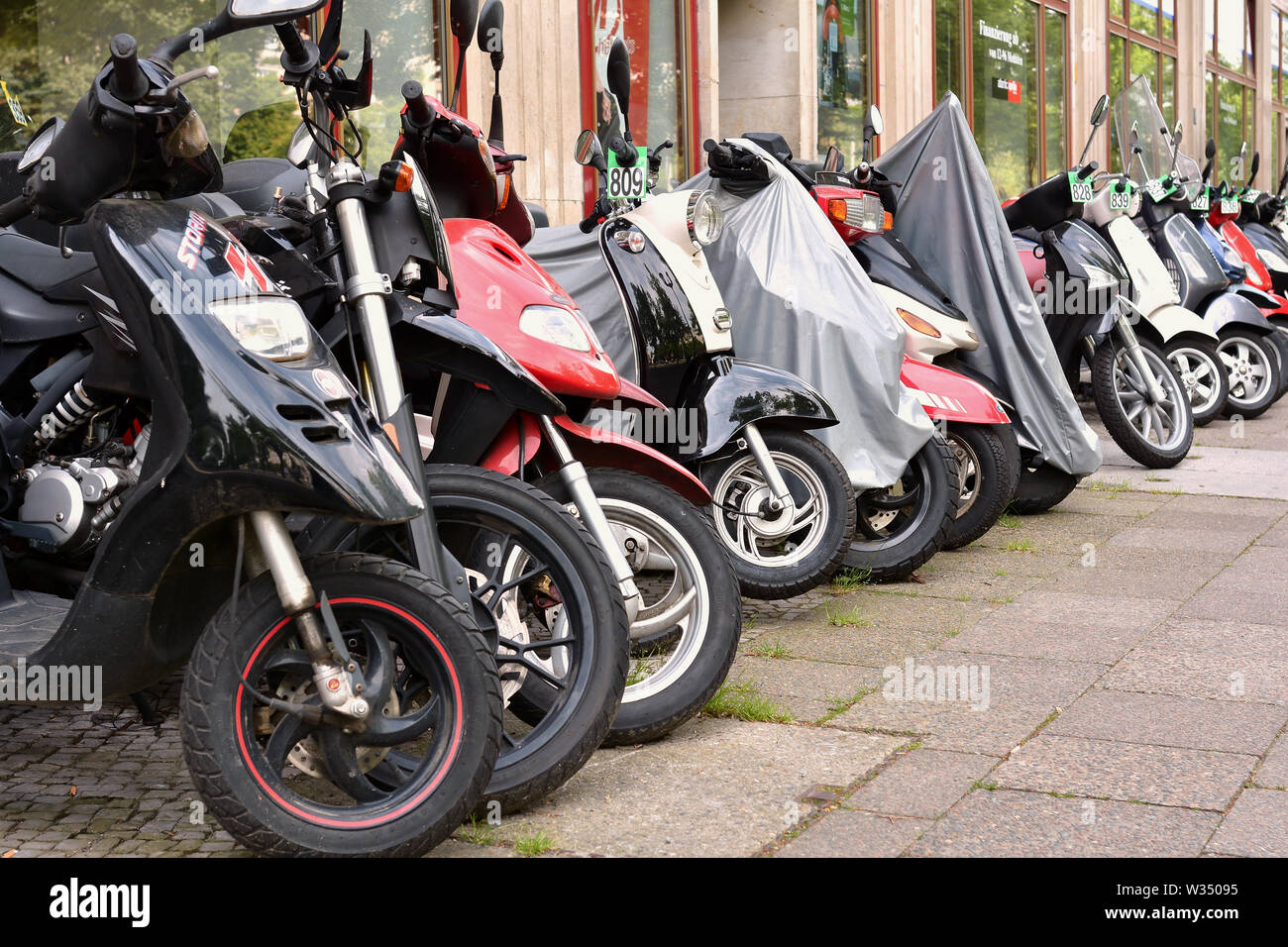 parked scooters in downtown Berlin Stock Photo