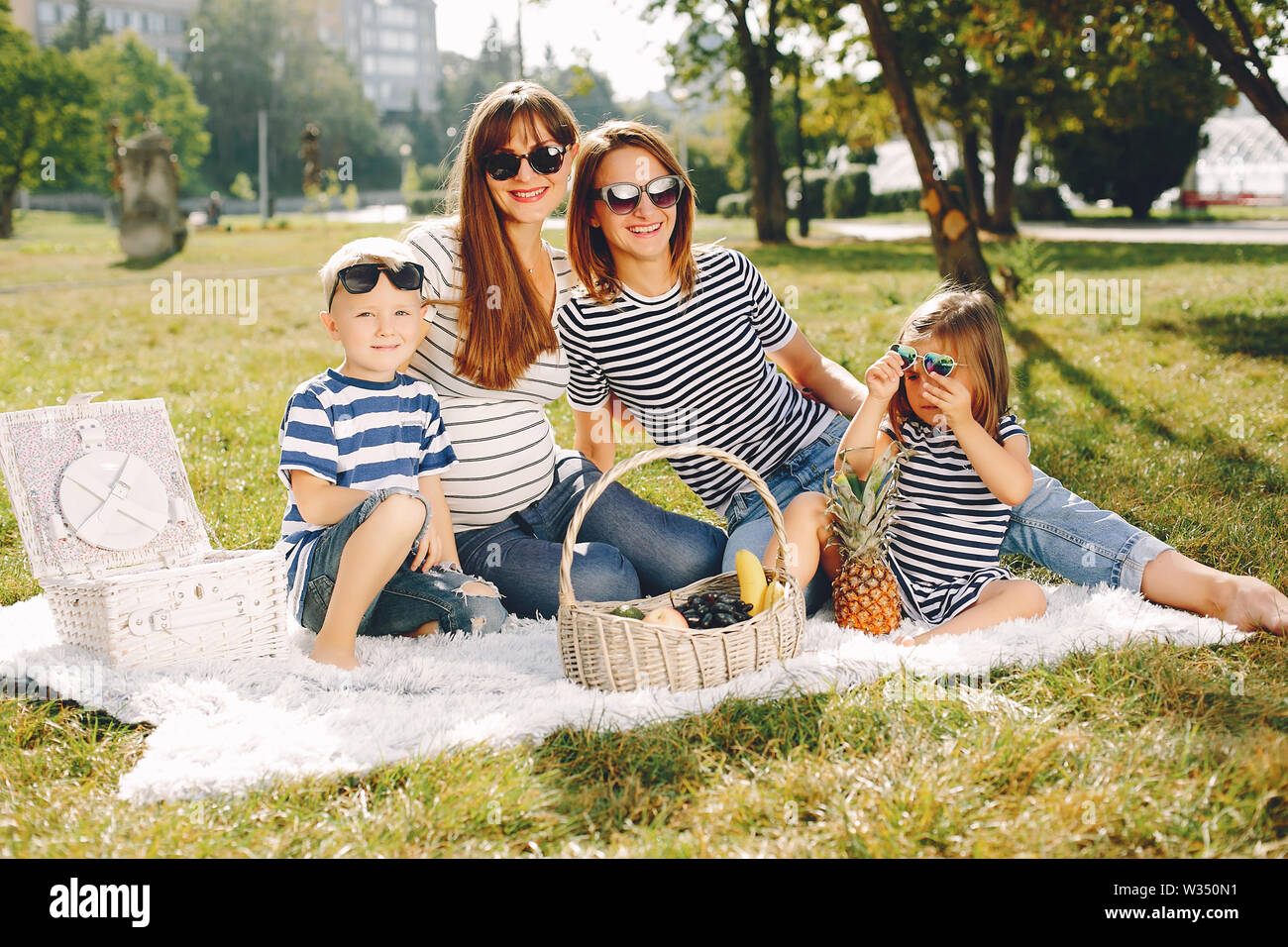 Mothers with kids playing in a summer park Stock Photo - Alamy