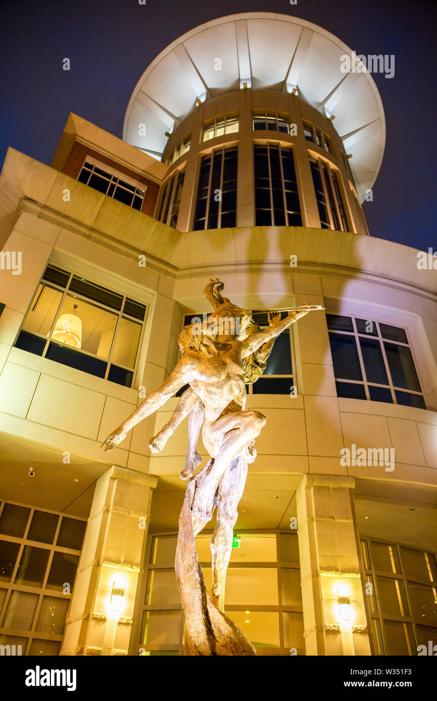 GREENVILLE, SC (USA) - July 5, 2019:  A night-time view of the downtown 210 S. Main Street building with sculpture in front. Stock Photo