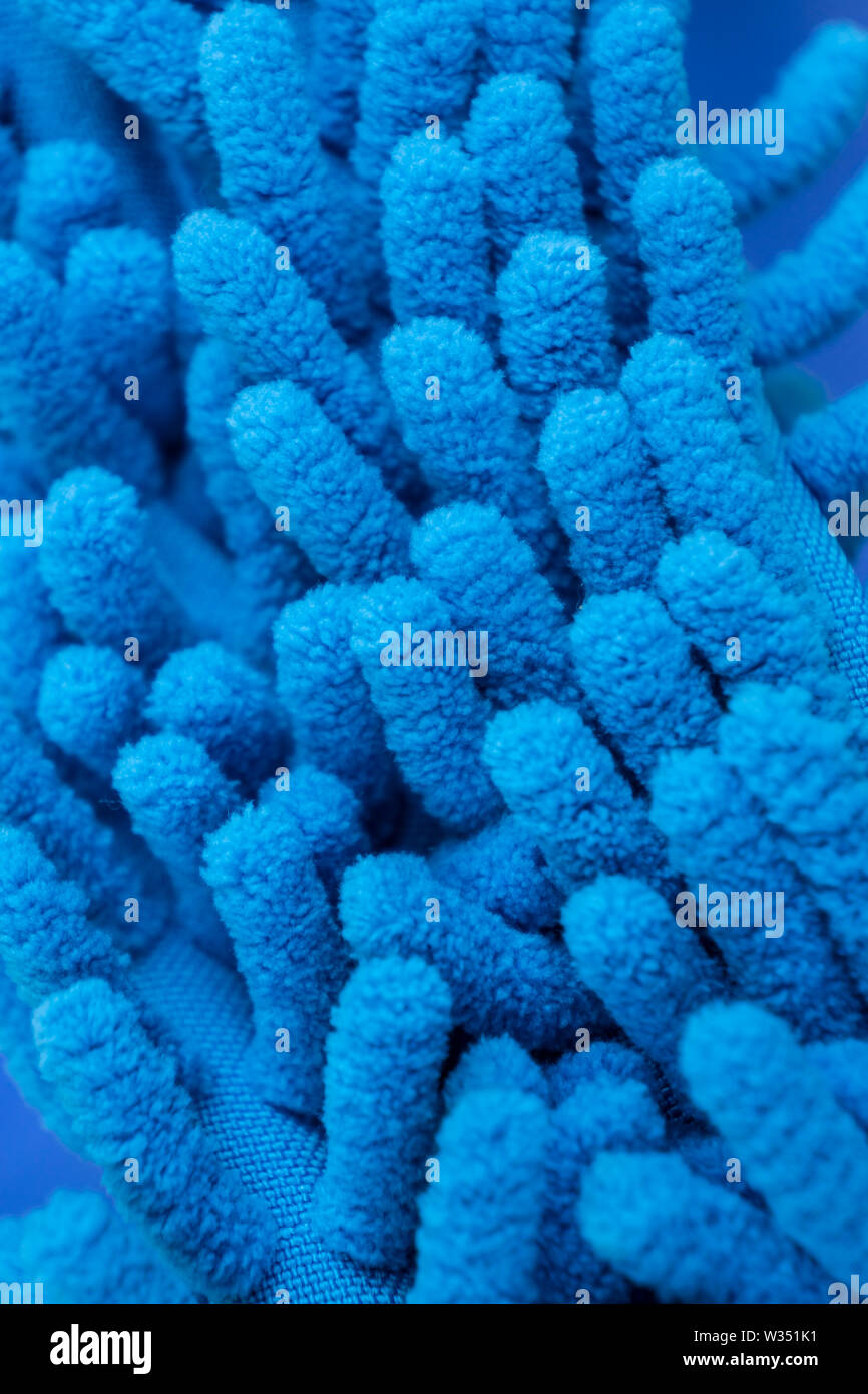 Macro close up of blue chenille microfiber texture for cleaning and trapping dust. Micro fiber duster closeup with fibers textures - soft machine wash Stock Photo