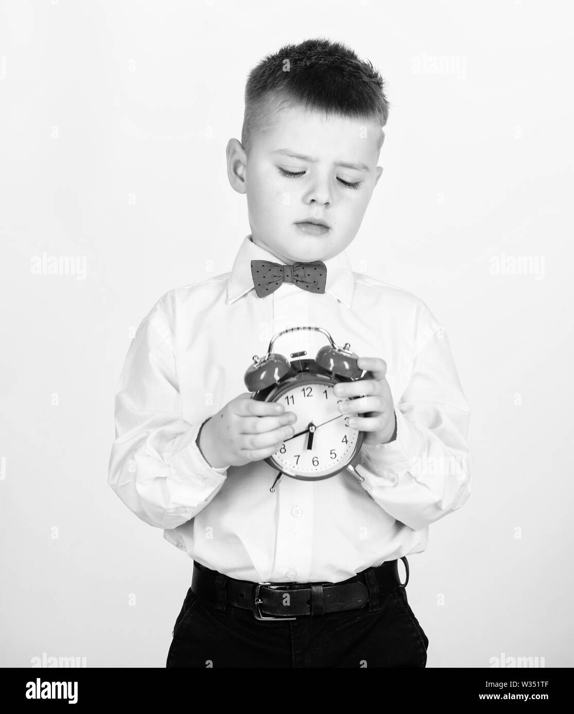 Develop self discipline. Set up alarm clock. Child little boy hold red