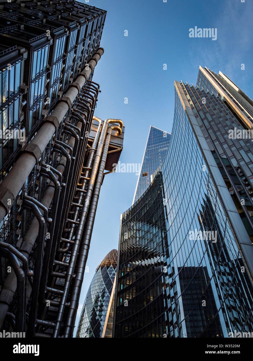 The golden hues of sunset on the outside of the Lloyds of London building Stock Photo