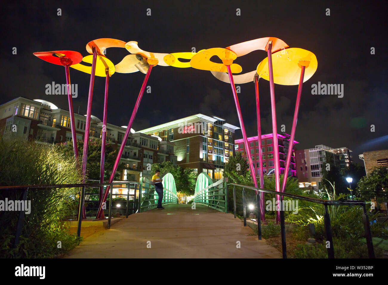 GREENVILLE, SC (USA) - July 5, 2019: A night-time view of the downtown River Walk with the River Place development of hotels, restaurants and shops. Stock Photo
