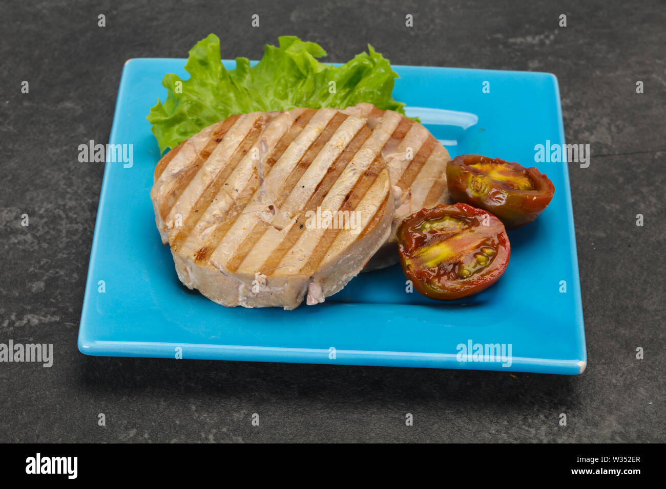 Grilled tuna steak with kumato and salad Stock Photo Alamy