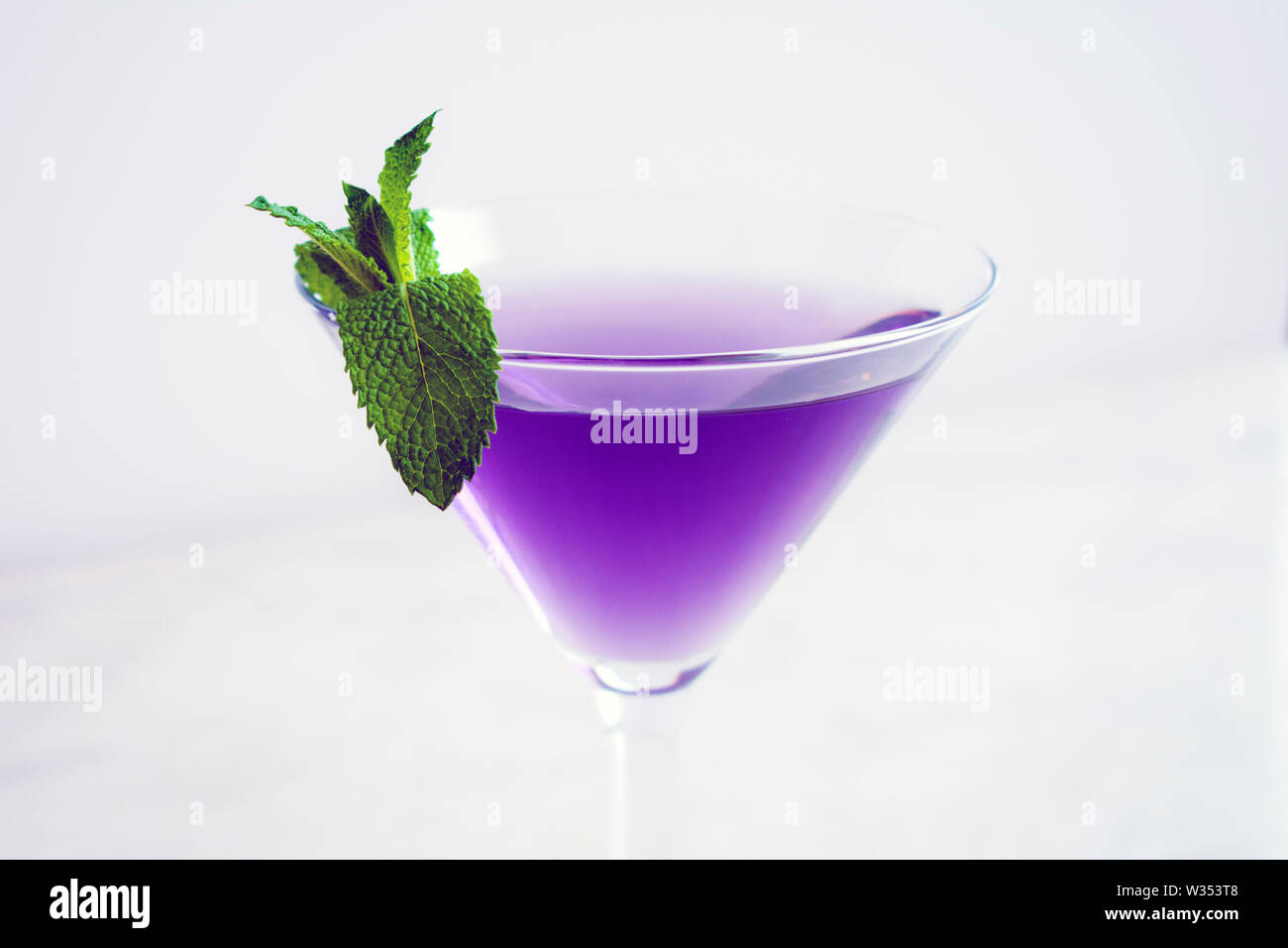 Purple Cocktail with Mint Garnish Stock Photo Alamy